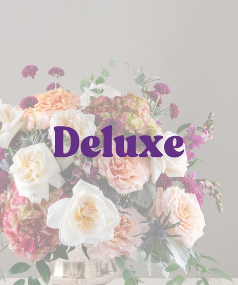 Elegant fall flower arrangement with cream roses, peach blooms, hydrangea, scabiosa, and blue thistle in a gold pedestal vase