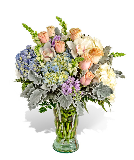 Pink, white, lavender and blue flowers in a lavish arrangement.