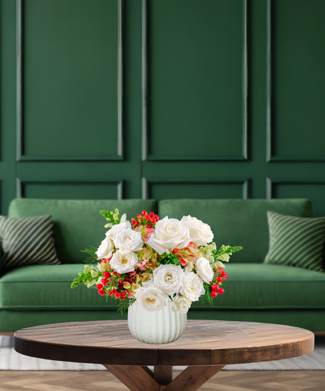 Berry Merry fresh Christmas flower arrangement with white roses, green and pink hydrangeas, red hypericum berries, and green Bells of Ireland in a textured white vase
