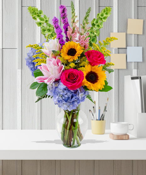 Brighten Her Day flower arrangement with sunflowers, hydrangeas, roses, lilies, and liatris in a glass vase – Admin Week appreciation bouquet.