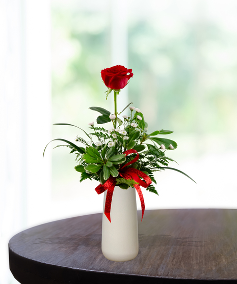 Valentine Bud Vase with six red roses, white baby's breath, and a red glitter ribbon in a tall white ceramic vase.