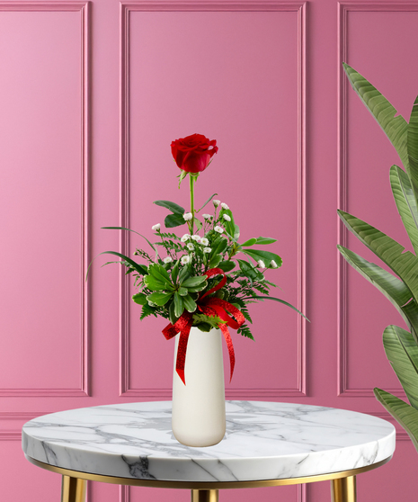 Valentine Bud Vase with six red roses, white baby's breath, and a red glitter ribbon in a tall white ceramic vase.
