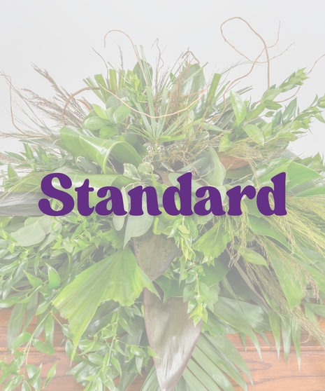 All-green casket cover with tropical foliage and natural elements – Sportsman’s Paradise Funeral Suite from Billy Heroman’s