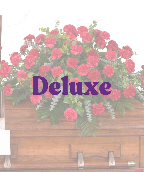 Classic red carnations casket cover with lush greenery from Billy Heroman’s in Baton Rouge, LA