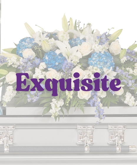 Blue and white casket cover with hydrangea, lilies, roses, and stock on silver casket