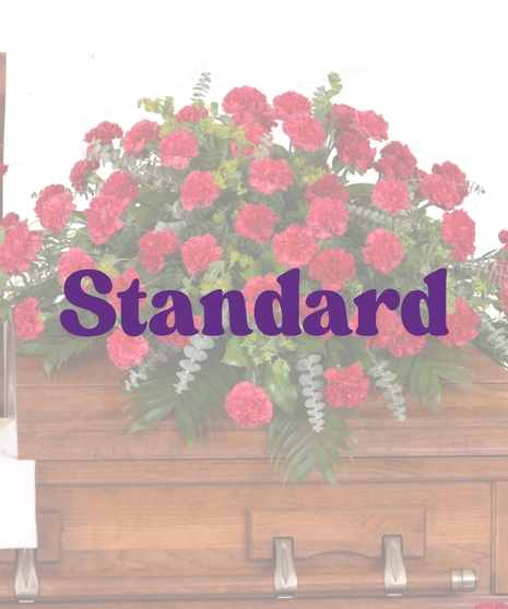 Classic red carnations casket cover with lush greenery from Billy Heroman’s in Baton Rouge, LA