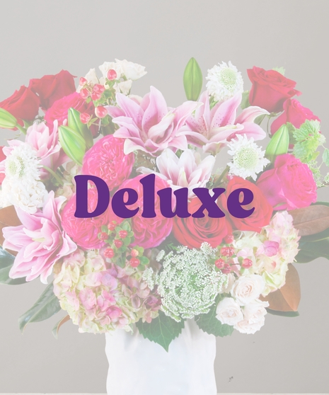 Chanel Signature Collection flower arrangement with hot pink roses, garden roses, white spray roses, Queen Anne’s lace, and more from Billy Heroman’s florist in Baton Rouge.