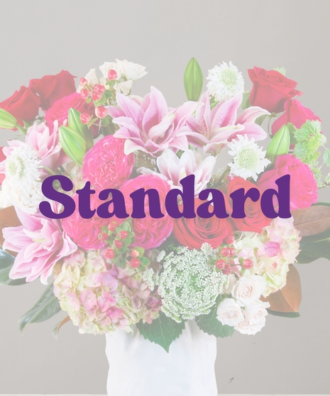 Chanel Signature Collection flower arrangement with hot pink roses, garden roses, white spray roses, Queen Anne’s lace, and more from Billy Heroman’s florist in Baton Rouge.
