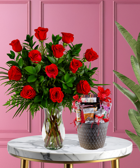 Chocolate Lover’s Delight package with red roses in a glass vase and a gourmet chocolate basket featuring Ferrero Rocher, Lugano truffles, and Russell Stover candies.