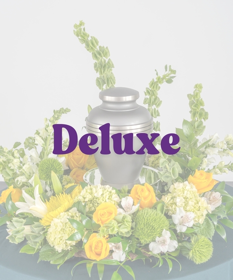 Golden yellow cremation flower arrangement with roses and lilies surrounding urn from Billy Heroman’s in Baton Rouge