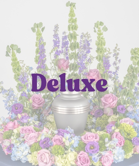 Bold Spring Mix cremation urn floral ring with pink roses, purple lisianthus, blue hydrangeas, and green bells of Ireland from Billy Heroman’s in Baton Rouge, LA