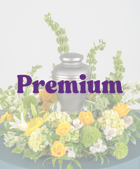Golden yellow cremation flower arrangement with roses and lilies surrounding urn from Billy Heroman’s in Baton Rouge