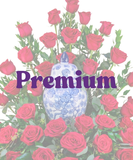 Cremation floral arrangement with red roses encircling a blue and white urn from Billy Heroman’s Florist in Baton Rouge, LA