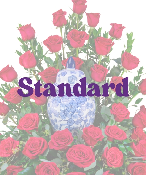 Cremation floral arrangement with red roses encircling a blue and white urn from Billy Heroman’s Florist in Baton Rouge, LA