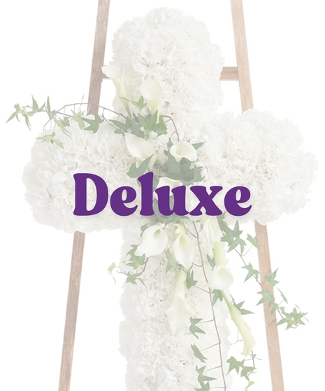 Elegant White Cross Stand with white carnations, cascading calla lilies, and ivy on a wooden easel