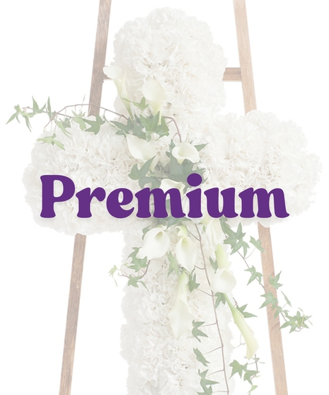 Elegant White Cross Stand with white carnations, cascading calla lilies, and ivy on a wooden easel