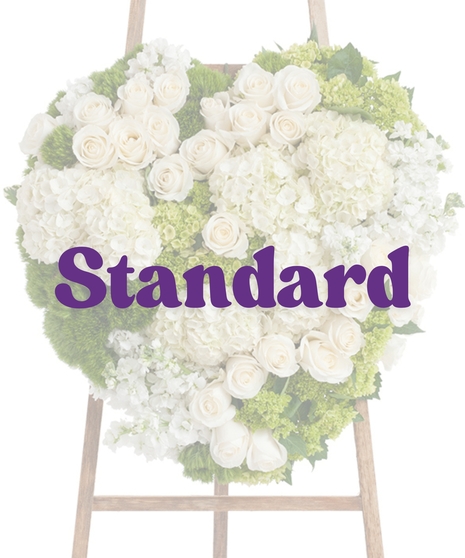 Elegant White Heart Stand with white roses, hydrangeas, and soft greenery on a wooden easel