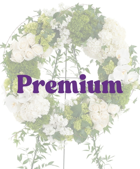 Elegant White Wreath Stand with white roses, hydrangeas, orchids, and green moss on a vine-covered easel