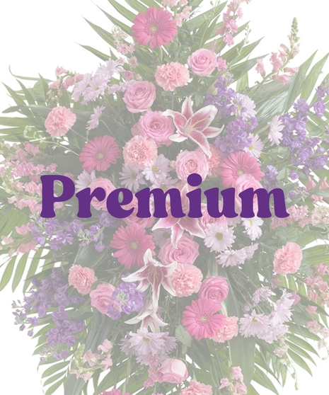 Feminine standing spray with stargazer lilies, roses, carnations, gerbera daisies, snapdragons, and purple stock on an easel