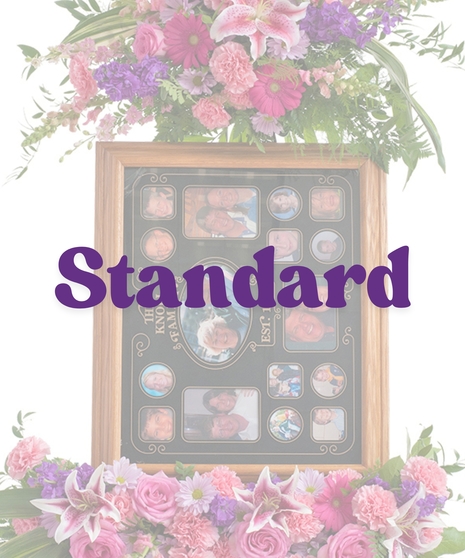 Floral picture frame stand with pink roses, carnations, lilies, daisies, and greenery surrounding a memory collage