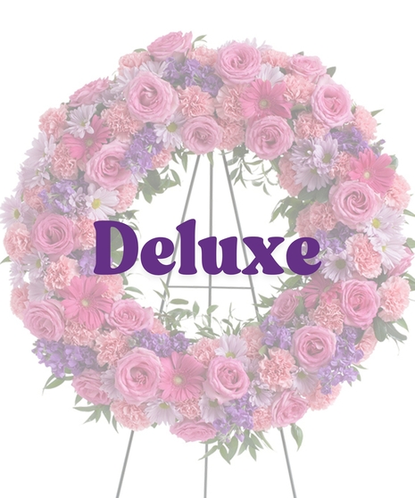 Feminine Funeral Wreath with pink roses, carnations, purple daisies, stock, and gerbera on a standing easel