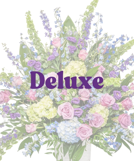Bold Spring Mix floor basket with pink roses, blue hydrangeas, purple lisianthus, and green accents in a birch-textured container from Billy Heroman’s in Baton Rouge, LA