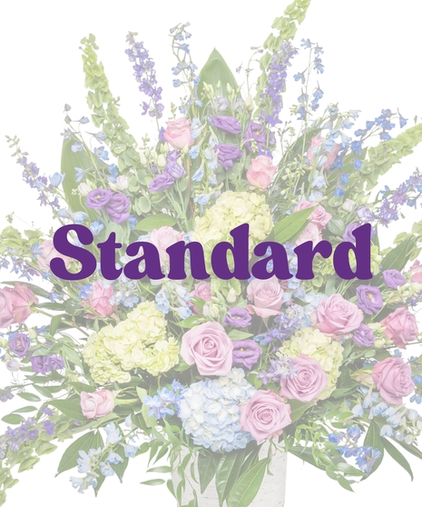 Bold Spring Mix floor basket with pink roses, blue hydrangeas, purple lisianthus, and green accents in a birch-textured container from Billy Heroman’s in Baton Rouge, LA
