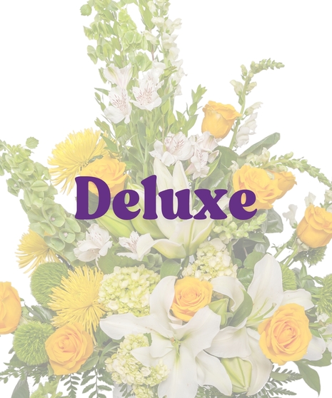 Bright yellow and white funeral floor basket with roses, lilies, snapdragons, and mums from Billy Heroman’s Florist in Baton Rouge