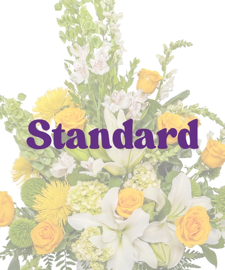 Bright yellow and white funeral floor basket with roses, lilies, snapdragons, and mums from Billy Heroman’s Florist in Baton Rouge