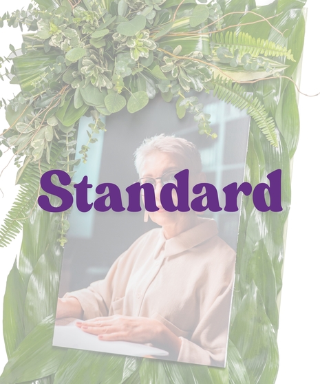 Memorial picture frame stand with lush green foliage and tropical leaves from Billy Heroman’s in Baton Rouge