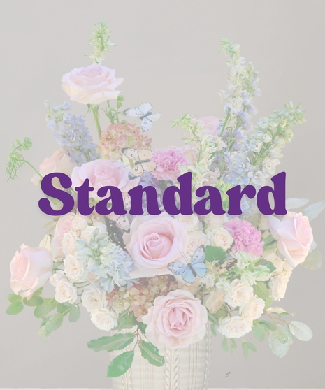 Francesca signature flower arrangement by Billy Heroman’s, featuring a mix of pink flowers and blue hydrangeas, perfect for a new baby or mother.