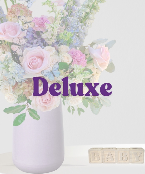 Butterfly Kisses signature flower arrangement by Billy Heroman’s, featuring a mix of pink flowers and blue hydrangeas, perfect for a new baby or mother.