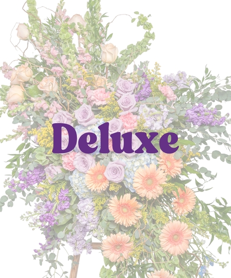 Pastel standing spray with lavender roses, peach gerberas, hydrangea, and garden blooms on a wooden easel from Billy Heroman’s in Baton Rouge