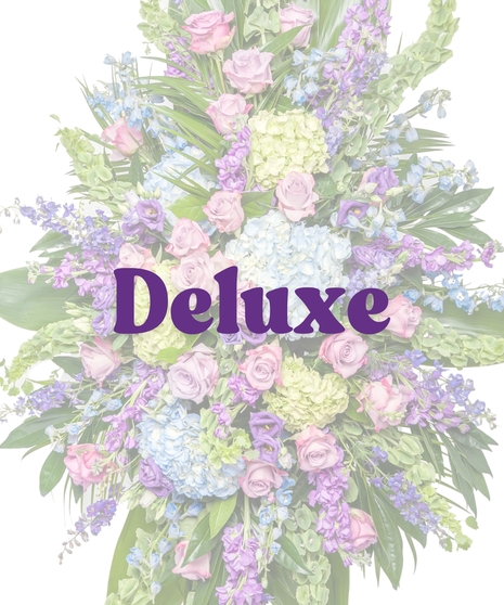 Bold Spring Mix funeral standing spray with pastel roses, hydrangea, and delphinium on easel by Billy Heroman’s in Baton Rouge, LA