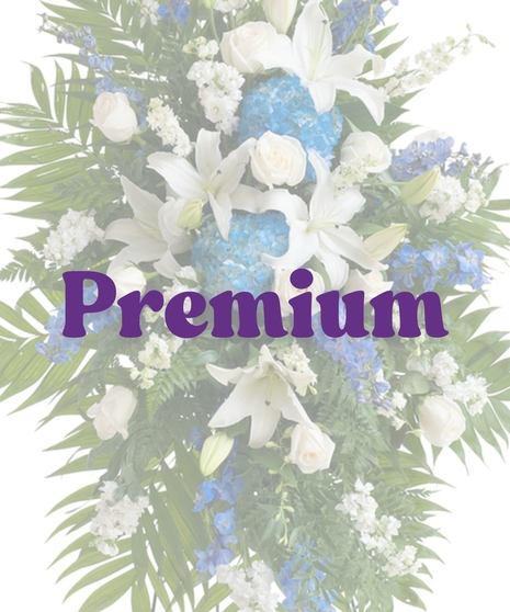 Standing funeral spray with blue hydrangea, white lilies, ivory roses, and greenery on easel