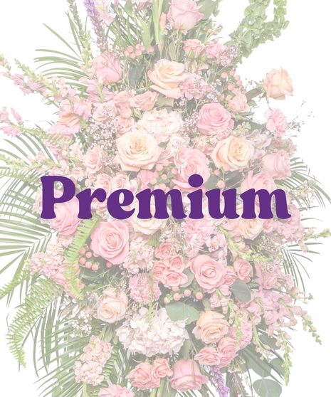 Tall funeral standing spray with pink roses, snapdragons, carnations, and lush greenery on an easel – Tender Blush Suite by Billy Heroman’s
