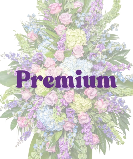 Bold Spring Mix funeral standing spray with pastel roses, hydrangea, and delphinium on easel by Billy Heroman’s in Baton Rouge, LA