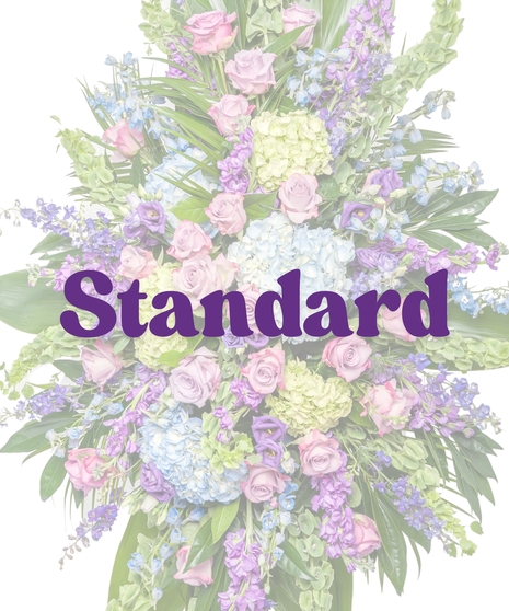 Bold Spring Mix funeral standing spray with pastel roses, hydrangea, and delphinium on easel by Billy Heroman’s in Baton Rouge, LA