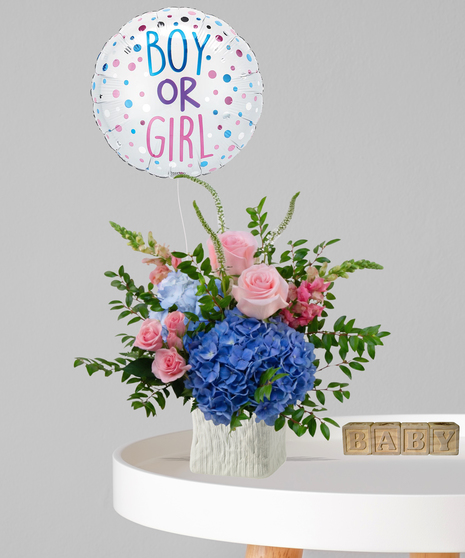 Pink roses and blue hydrangeas in a white textured vase with a 