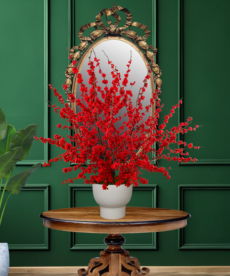 Ilex Berry Christmas arrangement with abundant red Ilex branches in a modern white ceramic vase