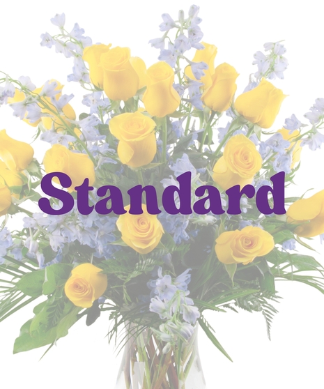 Vase arrangement with yellow roses and blue delphinium honoring Southern University colors