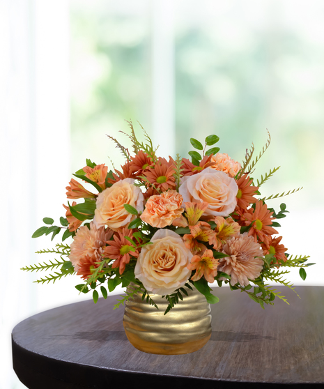 Just Peachy flower arrangement with peach roses, orange carnations, mums, and alstroemeria in a hammered copper vase.