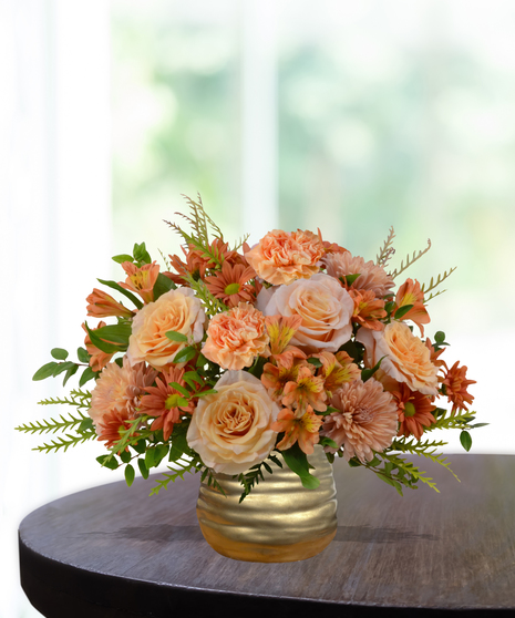 Just Peachy flower arrangement with peach roses, orange carnations, mums, and alstroemeria in a hammered copper vase.