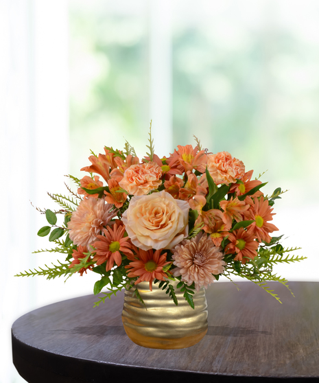Just Peachy flower arrangement with peach roses, orange carnations, mums, and alstroemeria in a hammered copper vase.