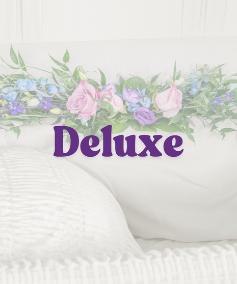 Bold Spring Mix casket lid piece with pink roses, purple lisianthus, and blue delphinium for funeral tribute by Billy Heroman’s in Baton Rouge, LA