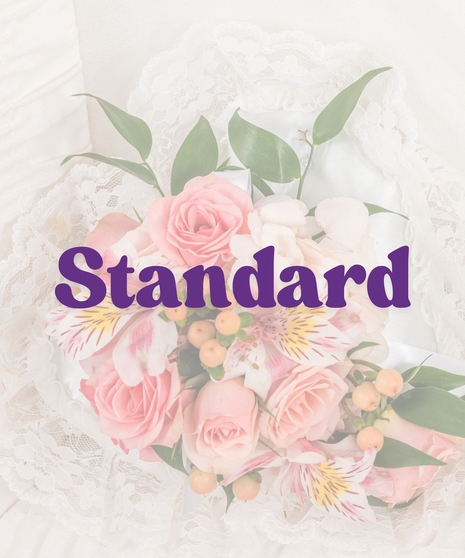 Casket lid piece with peach and pink spray roses, alstroemeria and lace backing inside a white satin-lined casket