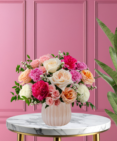 Hopeless Romantic luxury Valentine's arrangement with garden roses,  pink carnations, and lush greenery in a pearl pink ceramic vase.