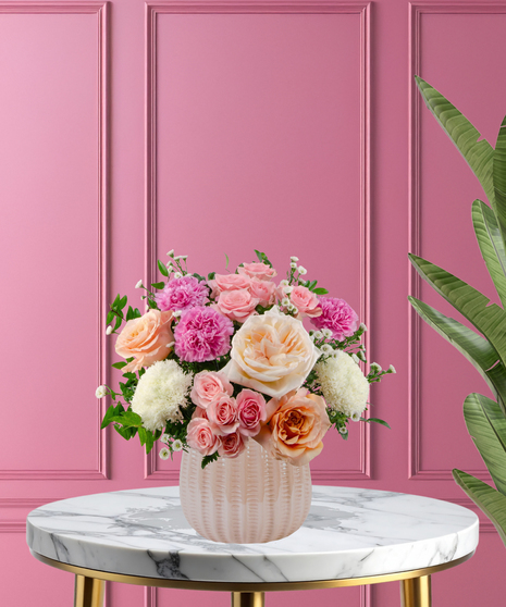 Hopeless Romantic luxury Valentine's arrangement with garden roses,  pink carnations, and lush greenery in a pearl pink ceramic vase.