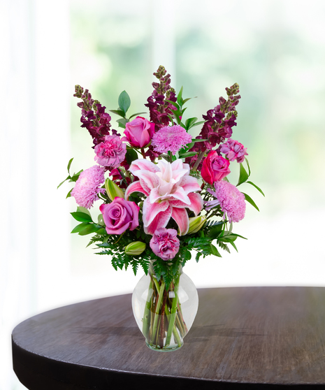 Lovely Lavenders everyday flower arrangement with rose lilies, roses, snapdragons, and lavender mums in a clear vase.