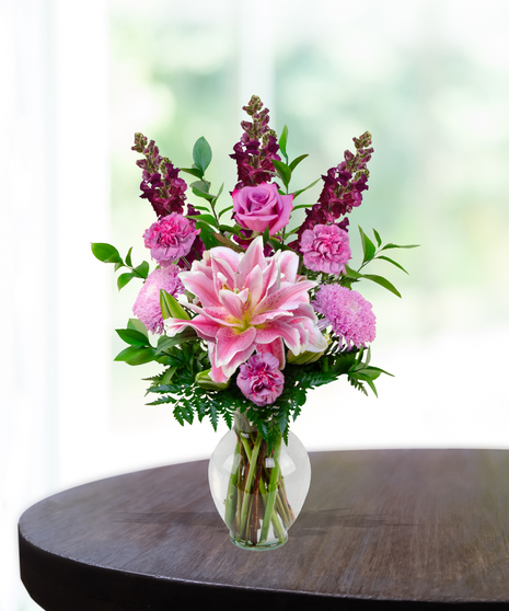 Lovely Lavenders everyday flower arrangement with rose lilies, roses, snapdragons, and lavender mums in a clear vase.